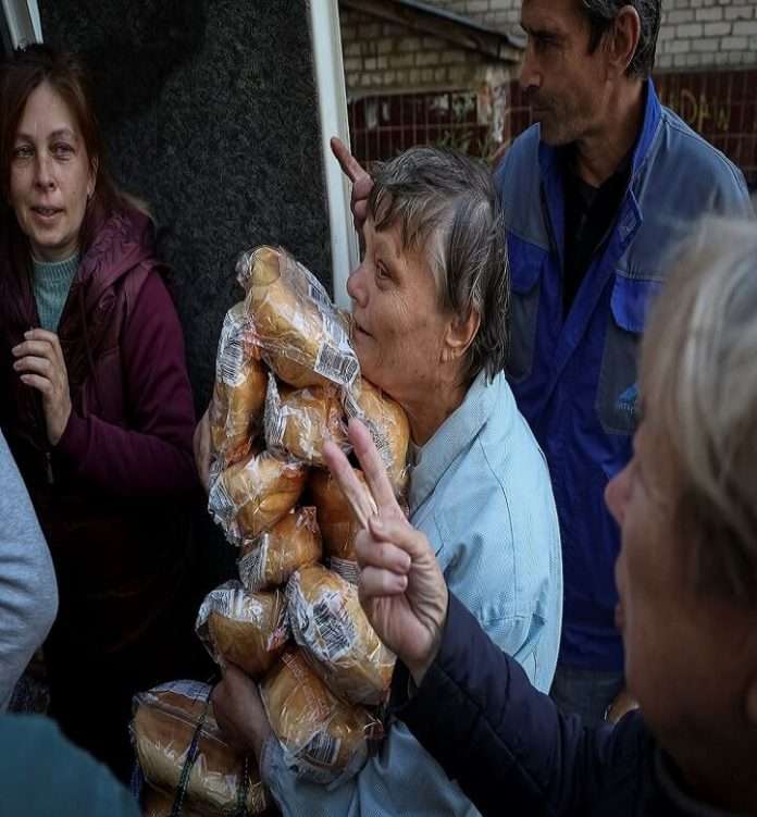 People of Ukraine receiving bread from humanitarian aid
